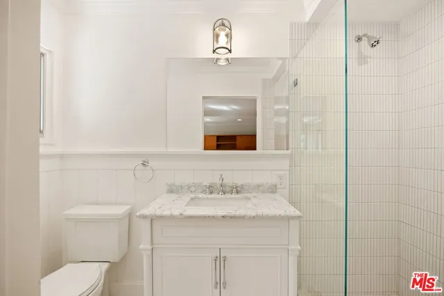 a view of a livingroom with wooden floor and a fireplace