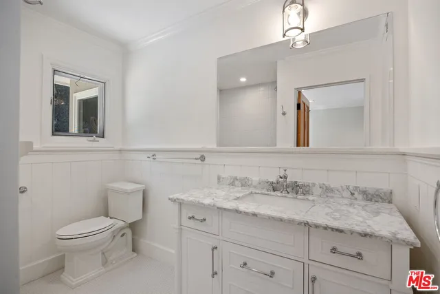 a spacious bathroom with a double vanity sink a mirror and a shower