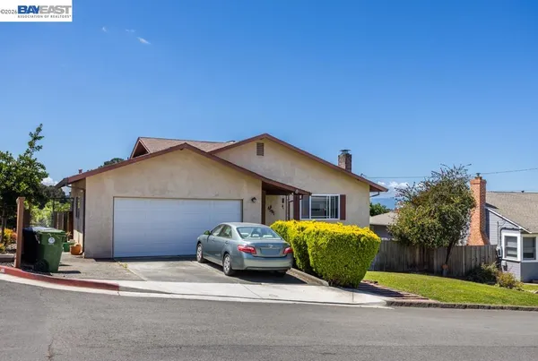 a view of a house with a patio and a yard