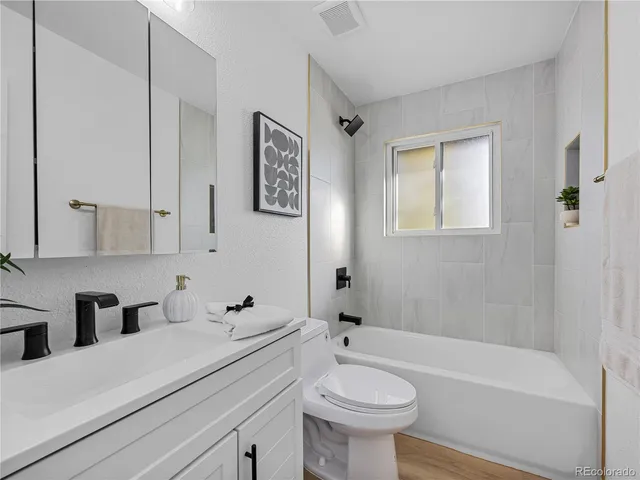 a bathroom with a sink a toilet and bathtub