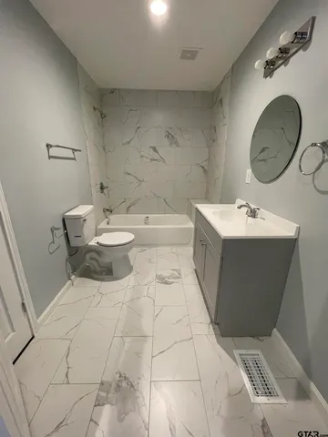 a bathroom with a sink a toilet and a mirror