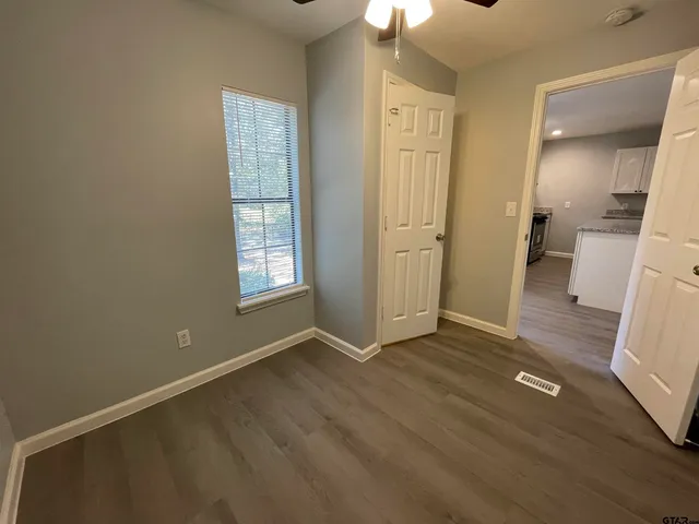 an empty room with wooden floor and a window