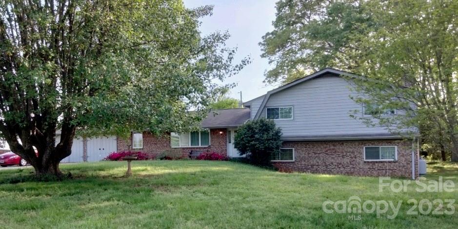 a front view of a house with a garden and yard
