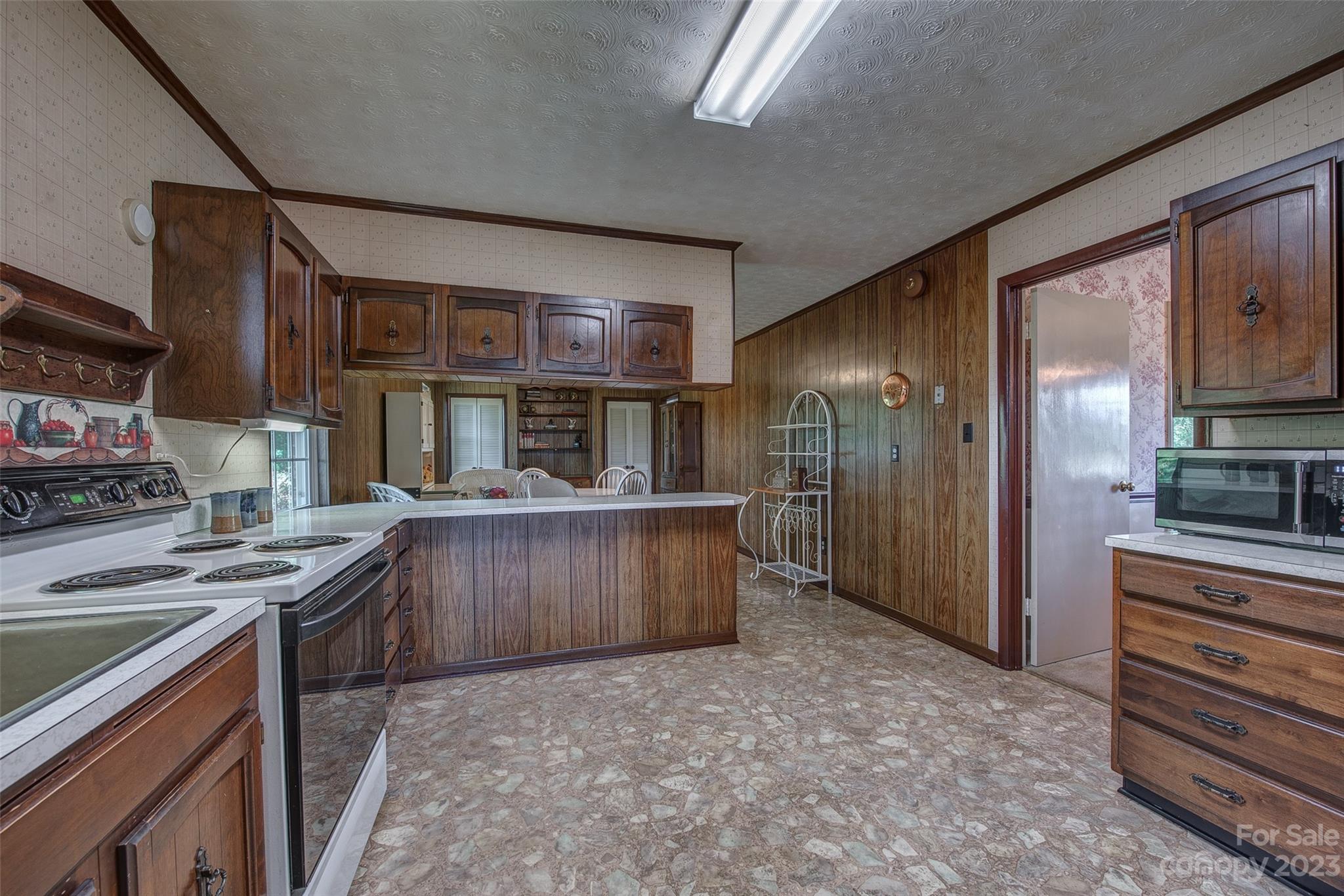 2141 New Prospect Church Road Shelby, NC 28150 - Photo 12 of 43 a kitchen with stainless steel appliances granite countertop a stove a refrigerator and a wooden cabinets
