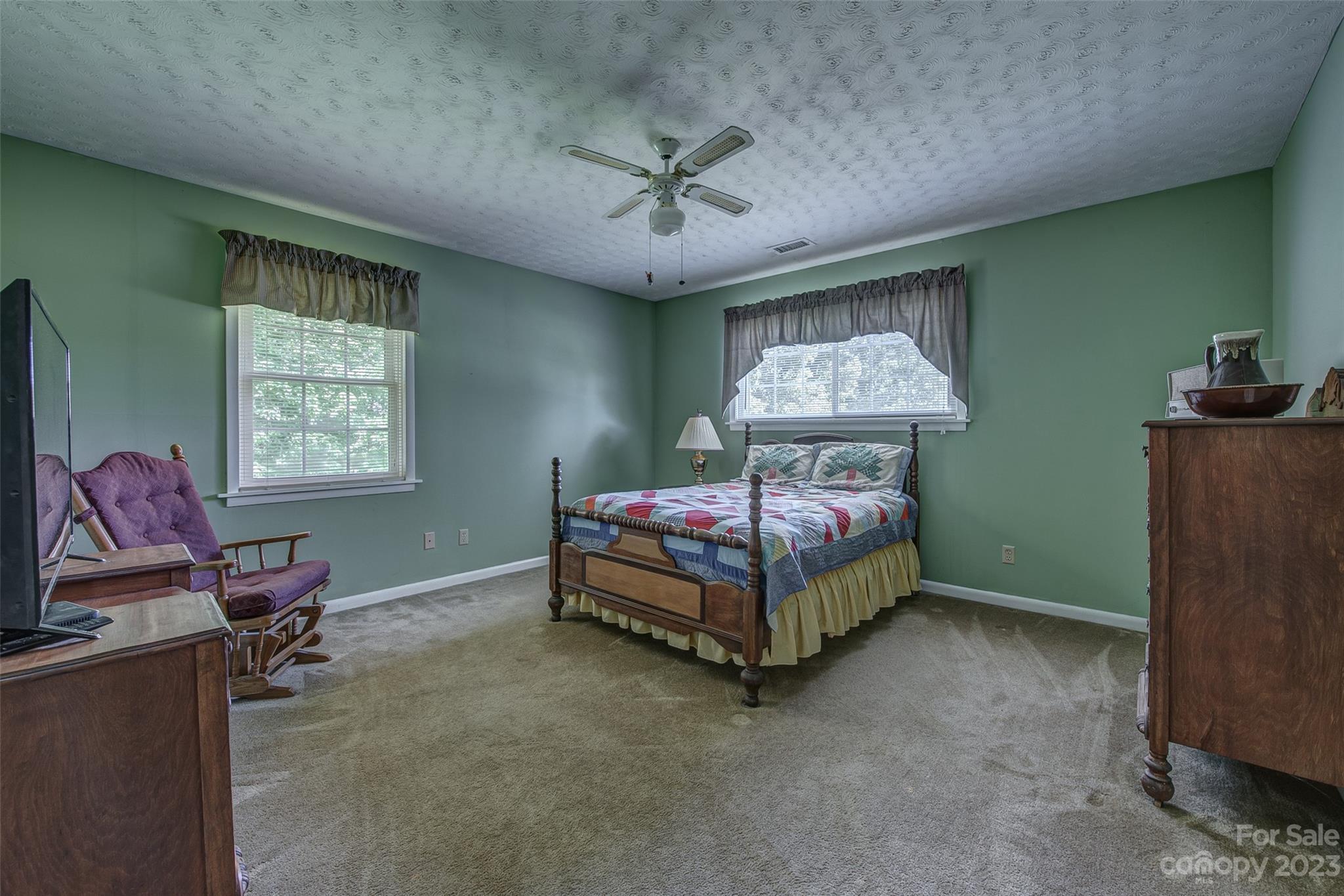 2141 New Prospect Church Road Shelby, NC 28150 - Photo 17 of 43 a bedroom with a bed and a chandelier