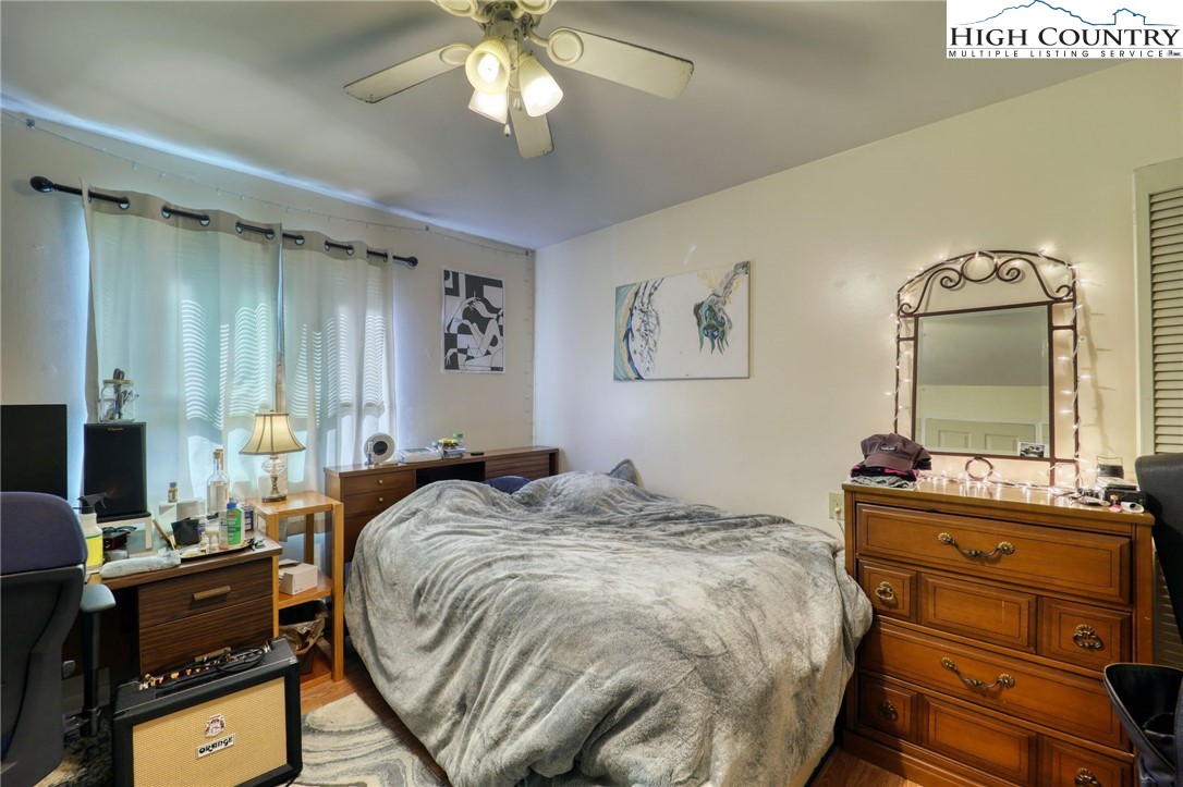 128 Zeb Street, Unit A106 Boone, NC 28607 - Photo 14 of 22 a bedroom with a bed and wooden floor