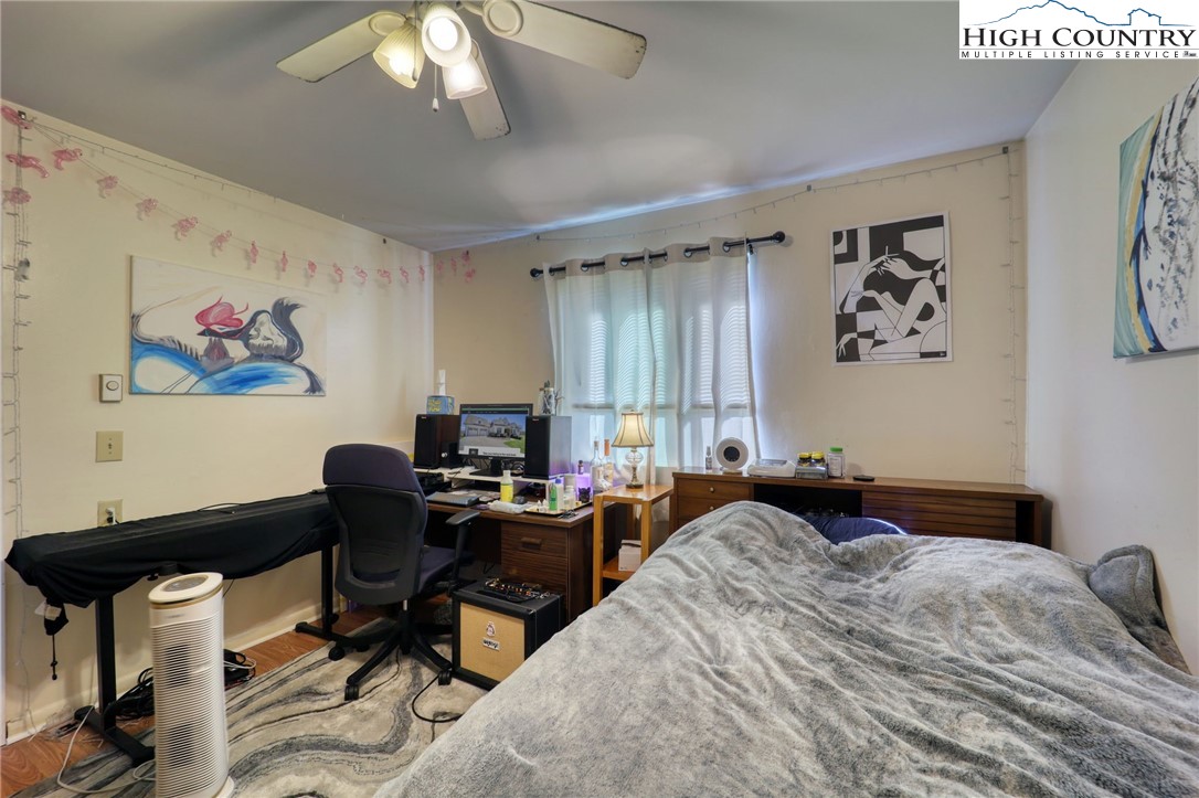 128 Zeb Street, Unit A106 Boone, NC 28607 - Photo 15 of 22 a bedroom with a bed and a chandelier