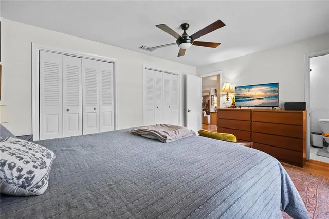 a bedroom with a bed and cabinets