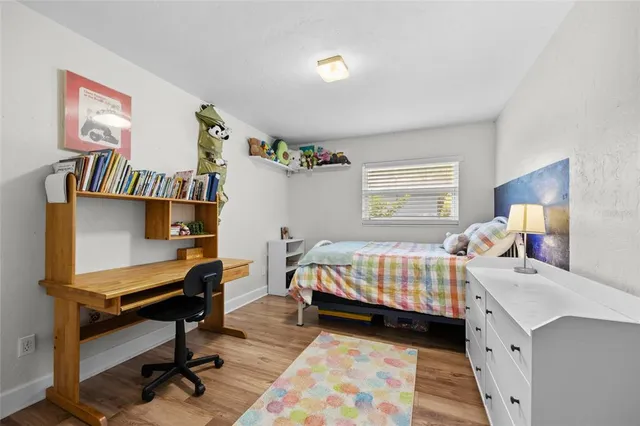 a bedroom with a bed and a desk