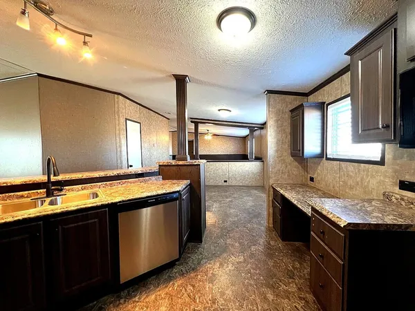 a kitchen with stainless steel appliances granite countertop a sink and a stove