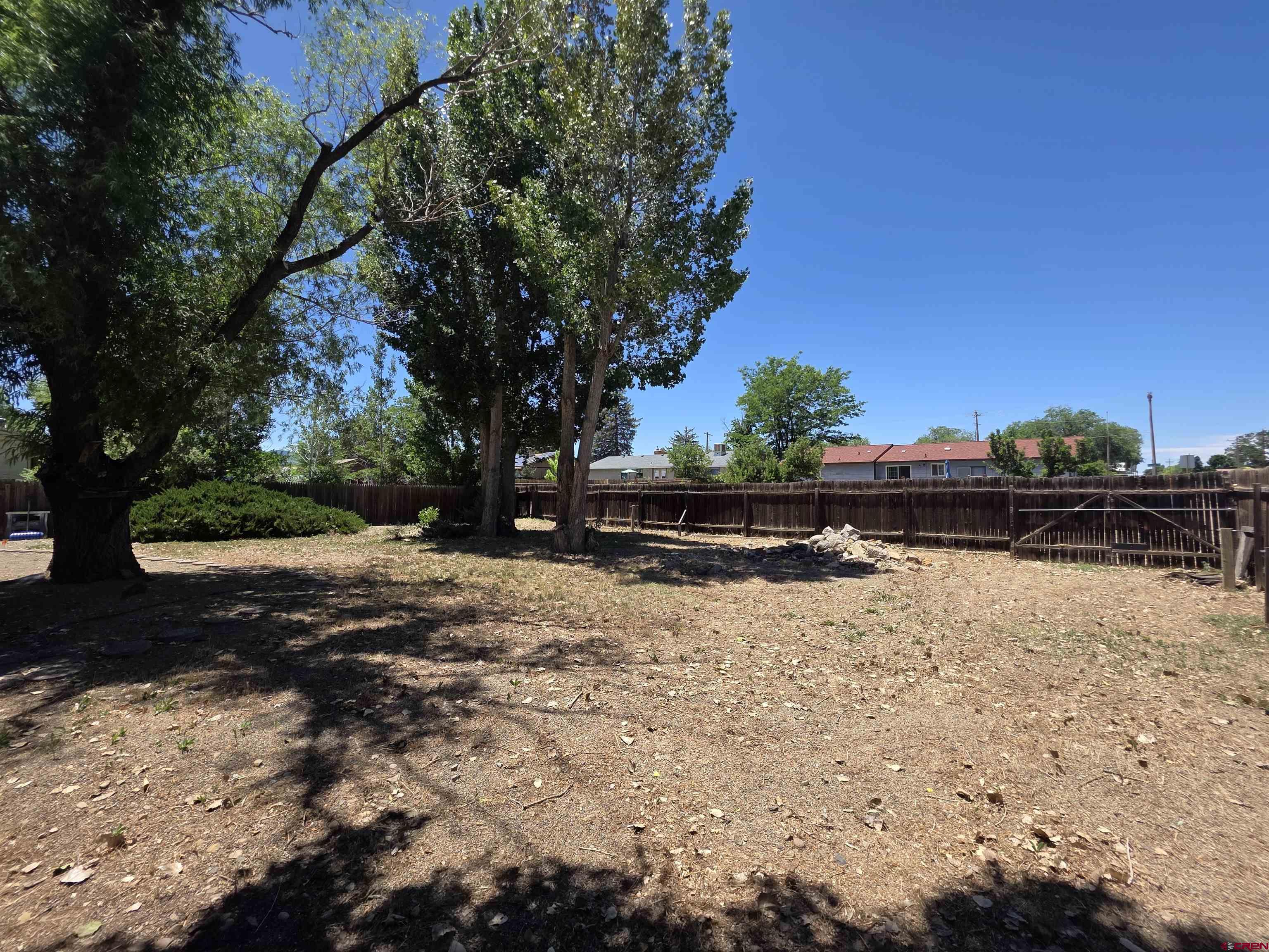 613 Colorado Street Cortez, CO 81321 - Photo 13 of 19 a backyard of a house with lots of green space