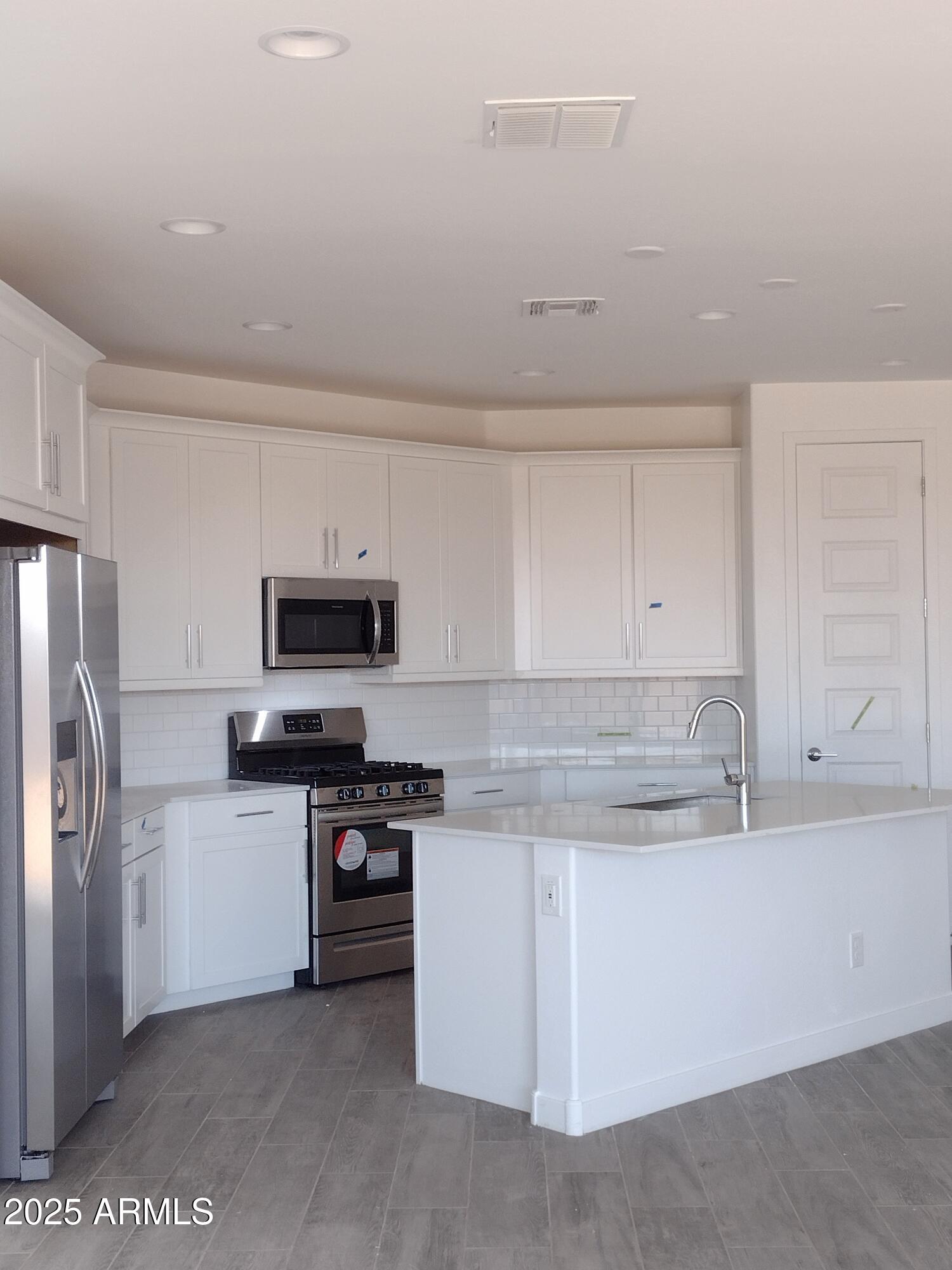 1536 West Corral Road Phoenix, AZ 85041 - Photo 3 of 16 a kitchen with stainless steel appliances granite countertop a refrigerator and a stove top oven