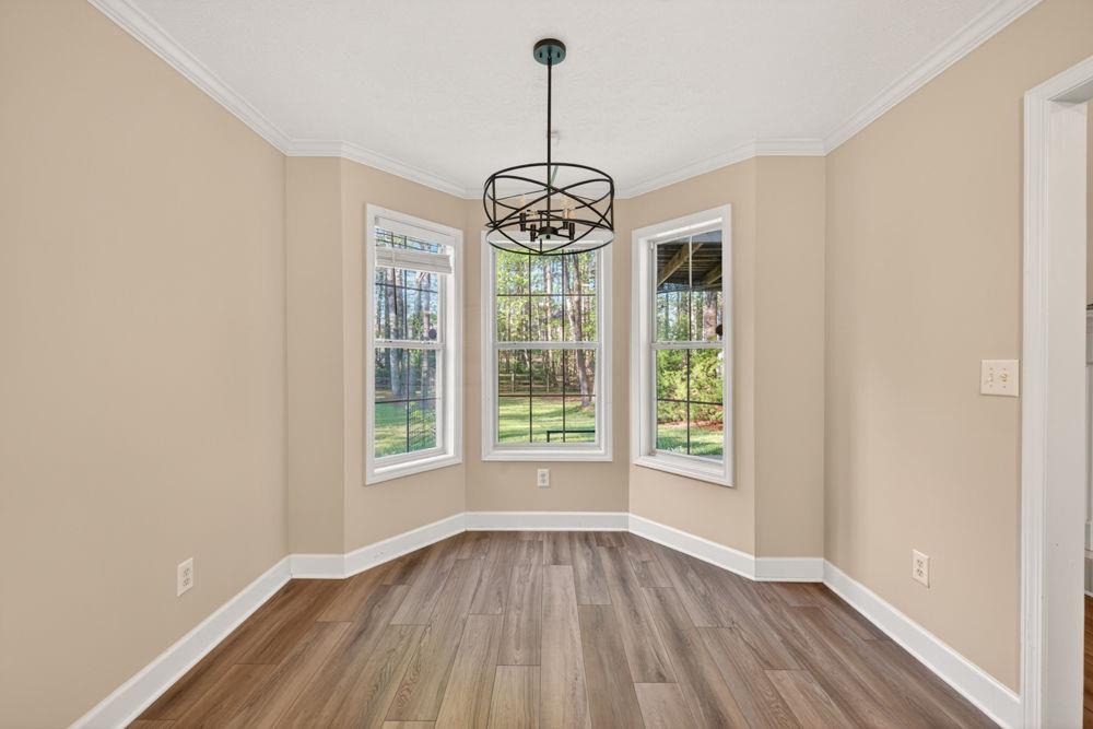 4035 Lakeside Boulevard Monroe, GA 30655 - Photo 14 of 43 a view of an empty room with wooden floor fridge and a window