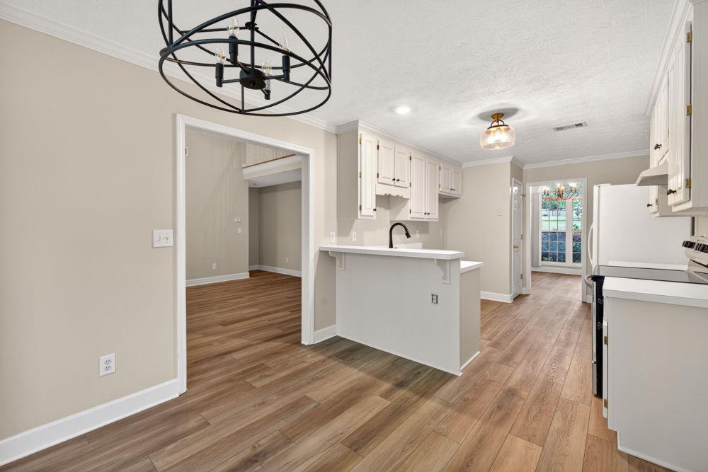 4035 Lakeside Boulevard Monroe, GA 30655 - Photo 15 of 43 a view of a kitchen with a sink and wooden floor
