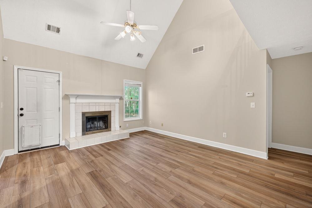 4035 Lakeside Boulevard Monroe, GA 30655 - Photo 16 of 43 a view of an empty room with wooden floor fireplace and a window