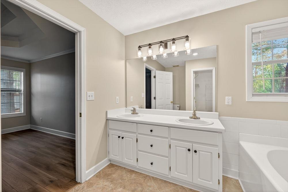 4035 Lakeside Boulevard Monroe, GA 30655 - Photo 19 of 43 a spacious bathroom with a double vanity sink a mirror and a bathtub