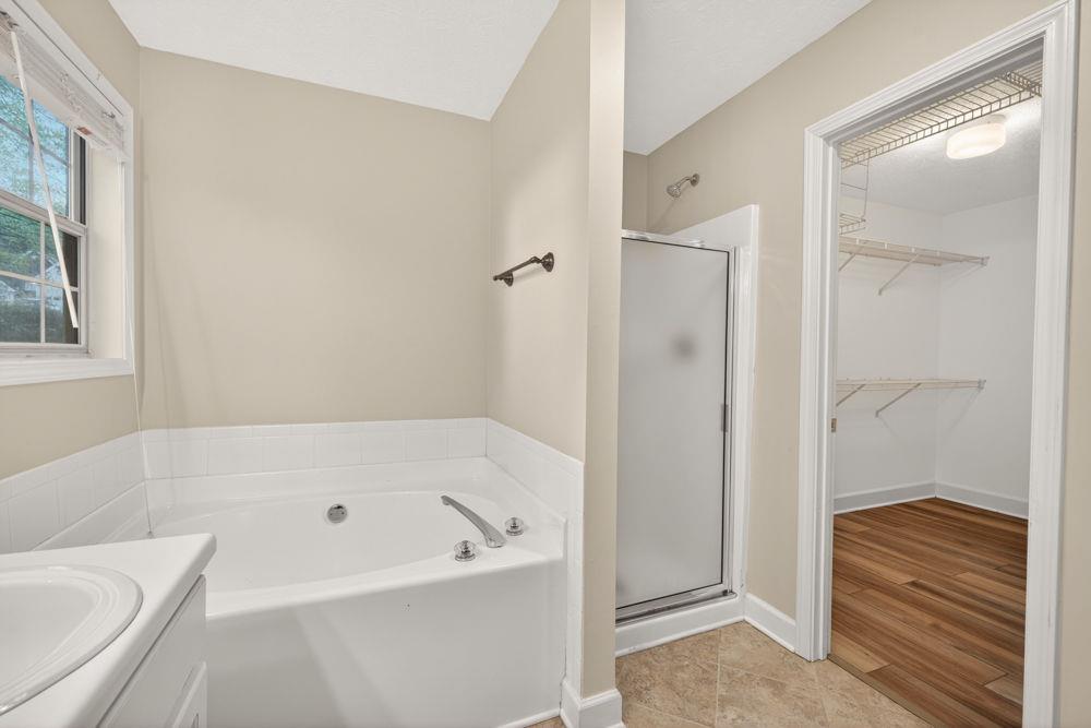 4035 Lakeside Boulevard Monroe, GA 30655 - Photo 20 of 43 a bathroom with a bathtub and a shower