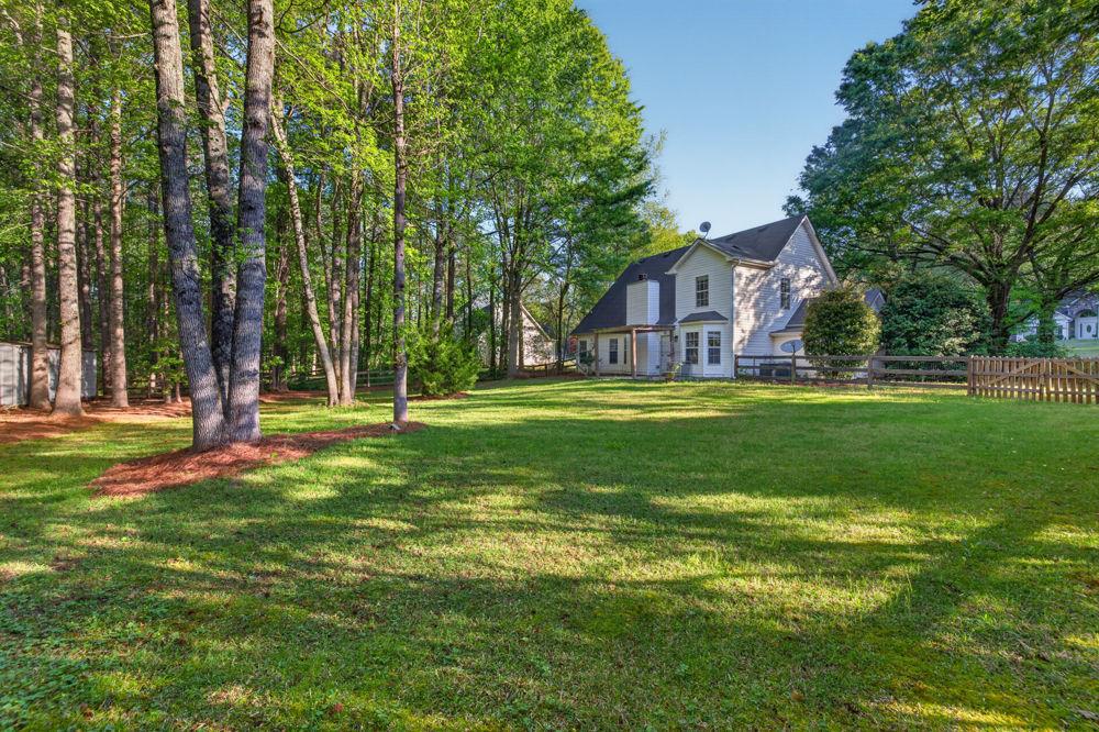 4035 Lakeside Boulevard Monroe, GA 30655 - Photo 2 of 43 a backyard of a house with lots of green space and fountain