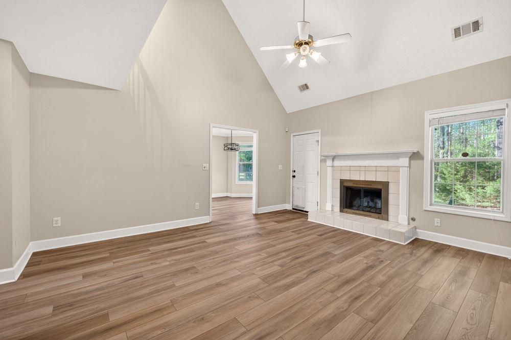 4035 Lakeside Boulevard Monroe, GA 30655 - Photo 23 of 43 a view of an empty room with wooden floor fireplace and a window