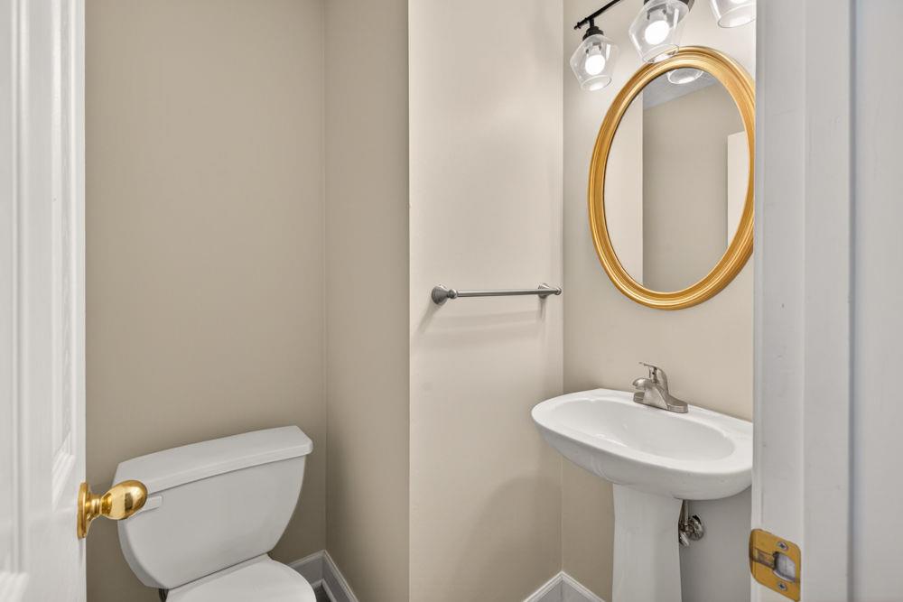 4035 Lakeside Boulevard Monroe, GA 30655 - Photo 25 of 43 a bathroom with a toilet sink and mirror