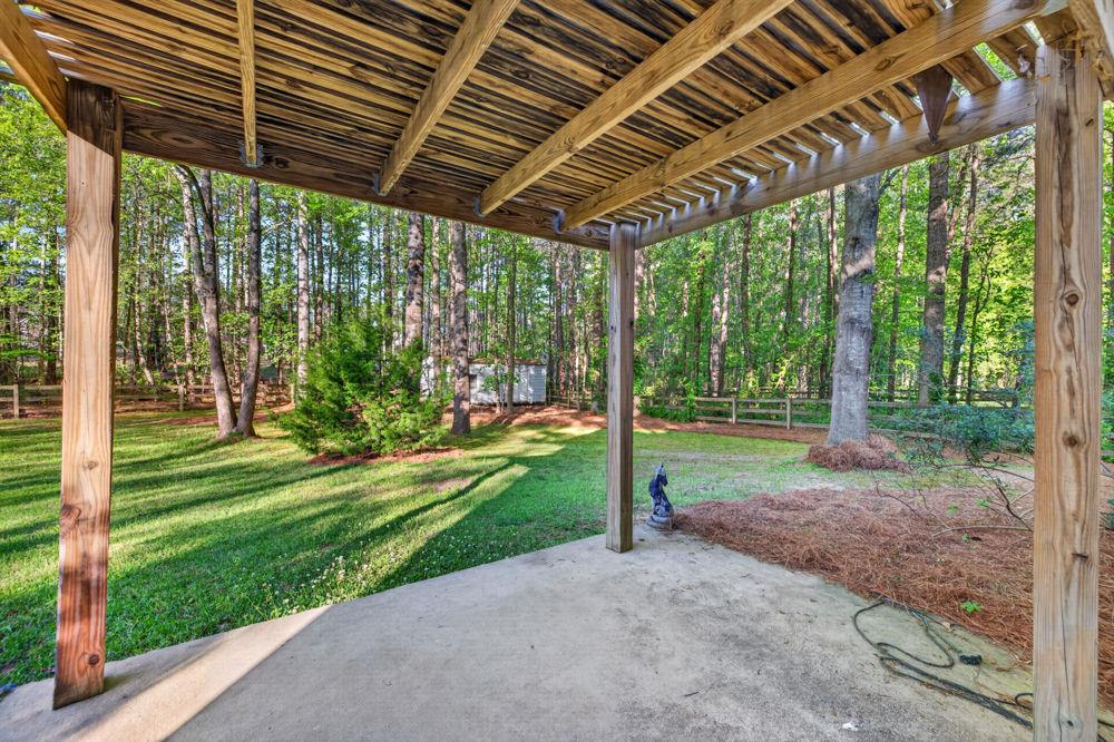 4035 Lakeside Boulevard Monroe, GA 30655 - Photo 38 of 43 a view of a porch in front of a house with a big yard and potted plants