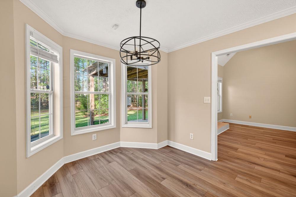 4035 Lakeside Boulevard Monroe, GA 30655 - Photo 6 of 43 a view of an empty room with wooden floor and windows