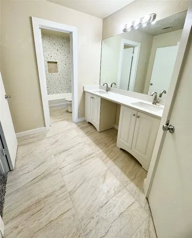 a view of a bathroom with sink and mirror