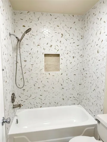 a bathroom with a toilet and a shower curtain