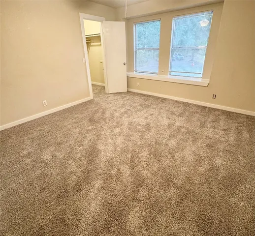 a front view of a house with a tree