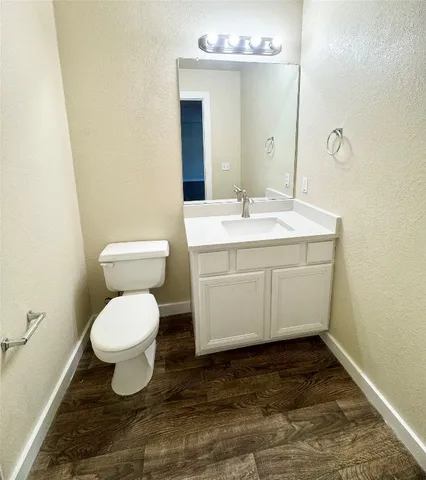 a bathroom with a sink toilet and mirror