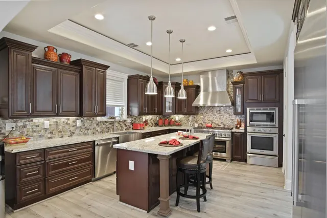 a kitchen with a sink stove and refrigerator