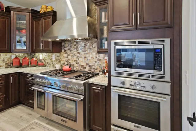 a stove top oven sitting inside of a kitchen