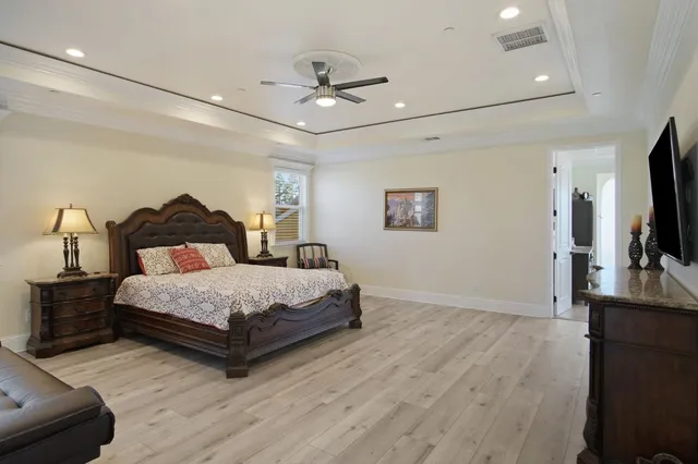 a bedroom with a bed window and a flat screen tv