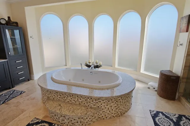 a living room with furniture and a mirror