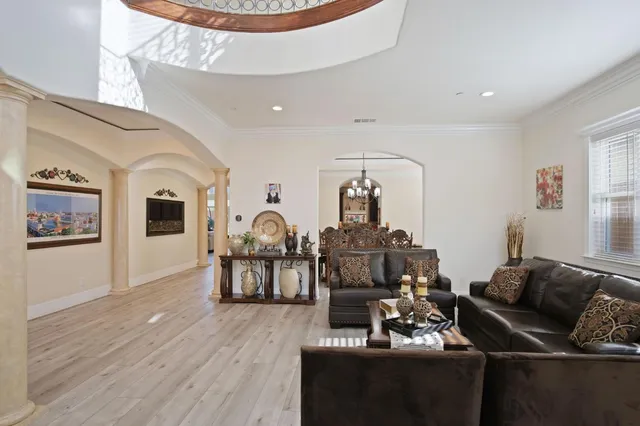 a living room with furniture a fireplace and wooden floor