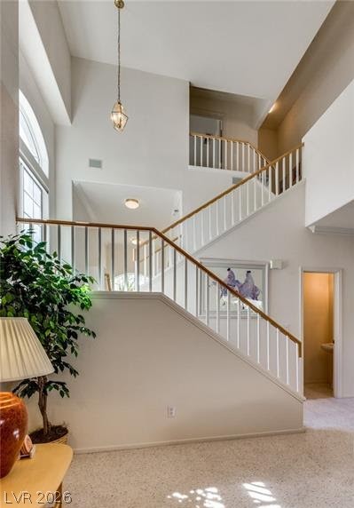 5272 Island Chain Road Las Vegas, NV 89118 - Photo 27 of 31 A graceful staircase with crisp white railings ascends through this airy, sun-filled entryway.