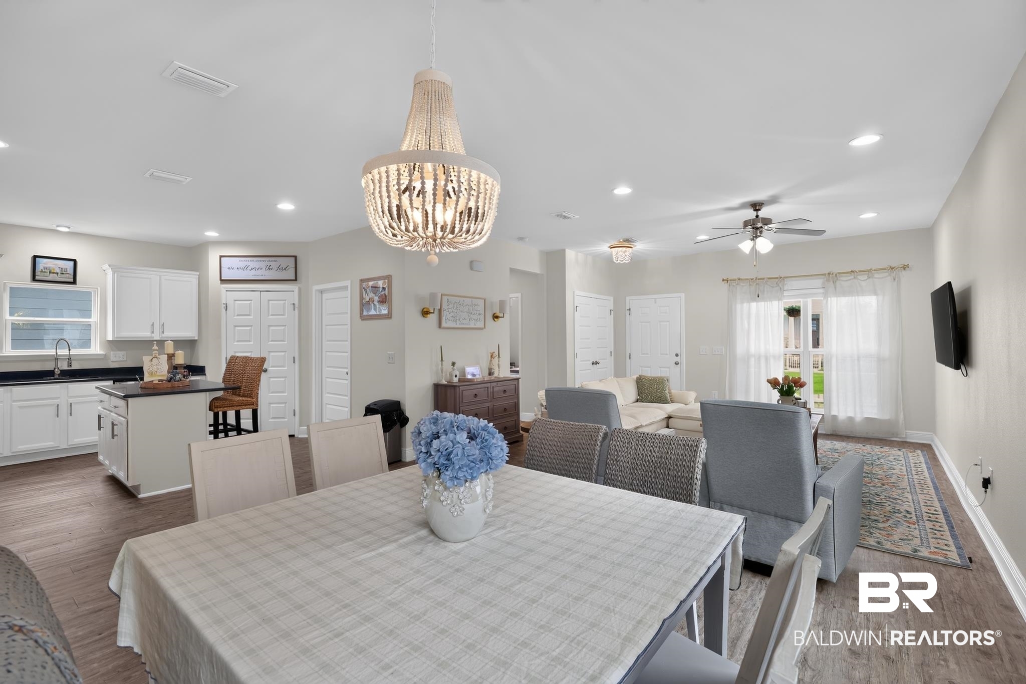 1210 Primrose Lane Foley, AL 36535 - Photo 12 of 33 Open-concept living space featuring wood-finish flooring, recessed lighting, and a decorative chandelier