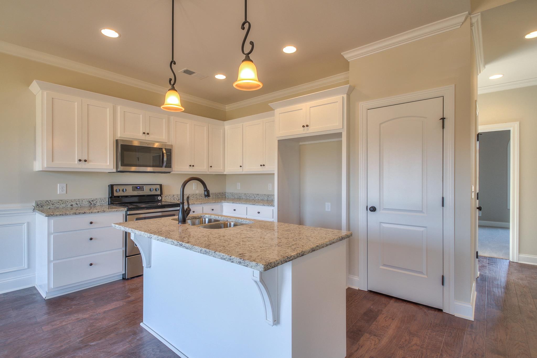 55 Harbor Pointe Lebanon, TN 37087 - Photo 21 of 29 a kitchen with stainless steel appliances granite countertop a refrigerator a sink a stove a microwave and wooden cabinets