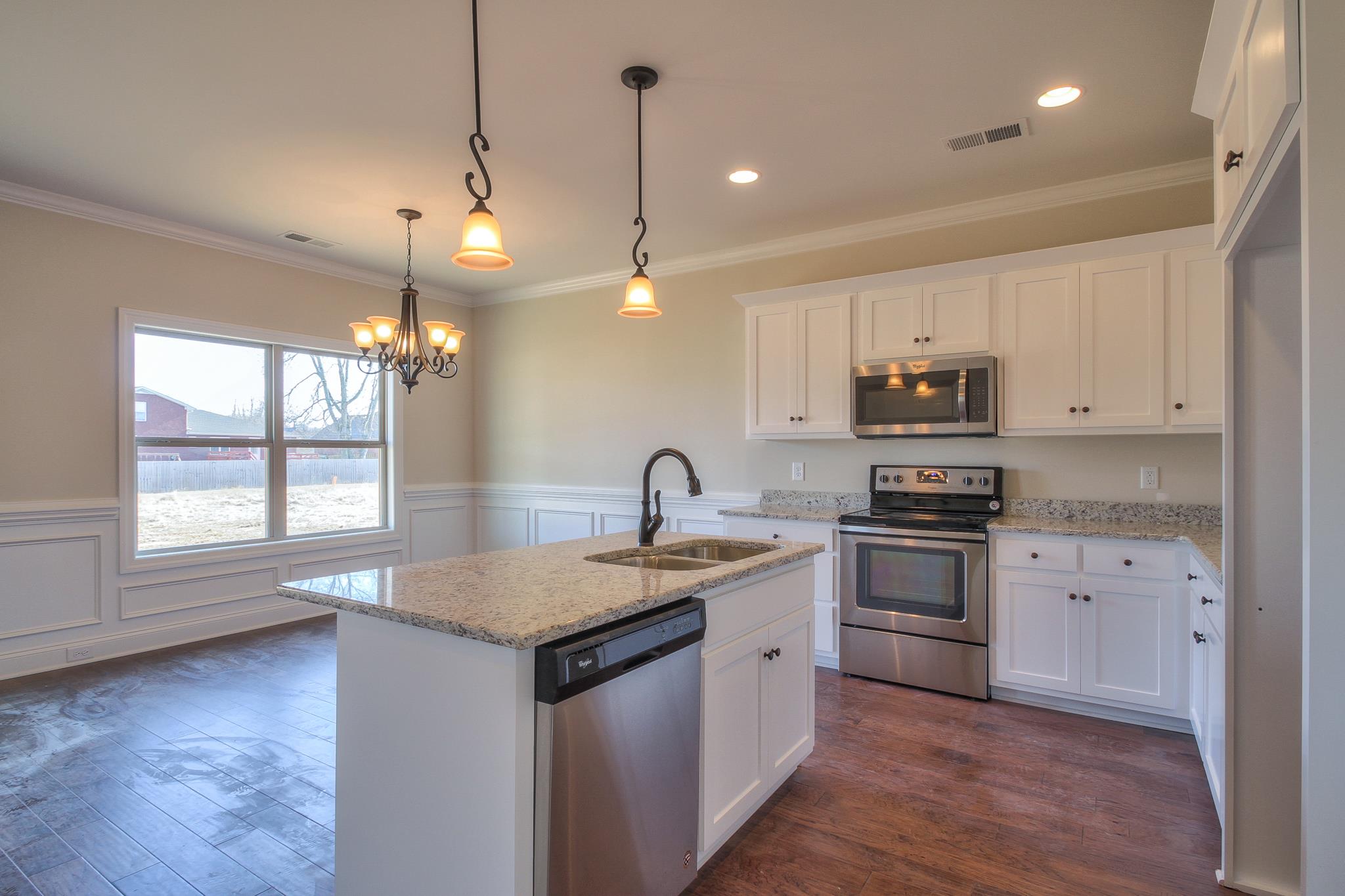 55 Harbor Pointe Lebanon, TN 37087 - Photo 22 of 29 a kitchen with stainless steel appliances granite countertop a sink dishwasher a stove and a refrigerator with wooden floor