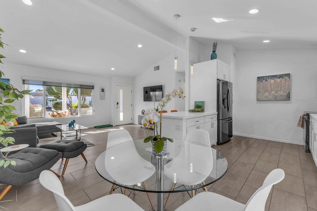 2304 East Bellamy Road Palm Springs, CA 92262 - Photo 32 of 32 a living room with stainless steel appliances furniture a dining table and kitchen view