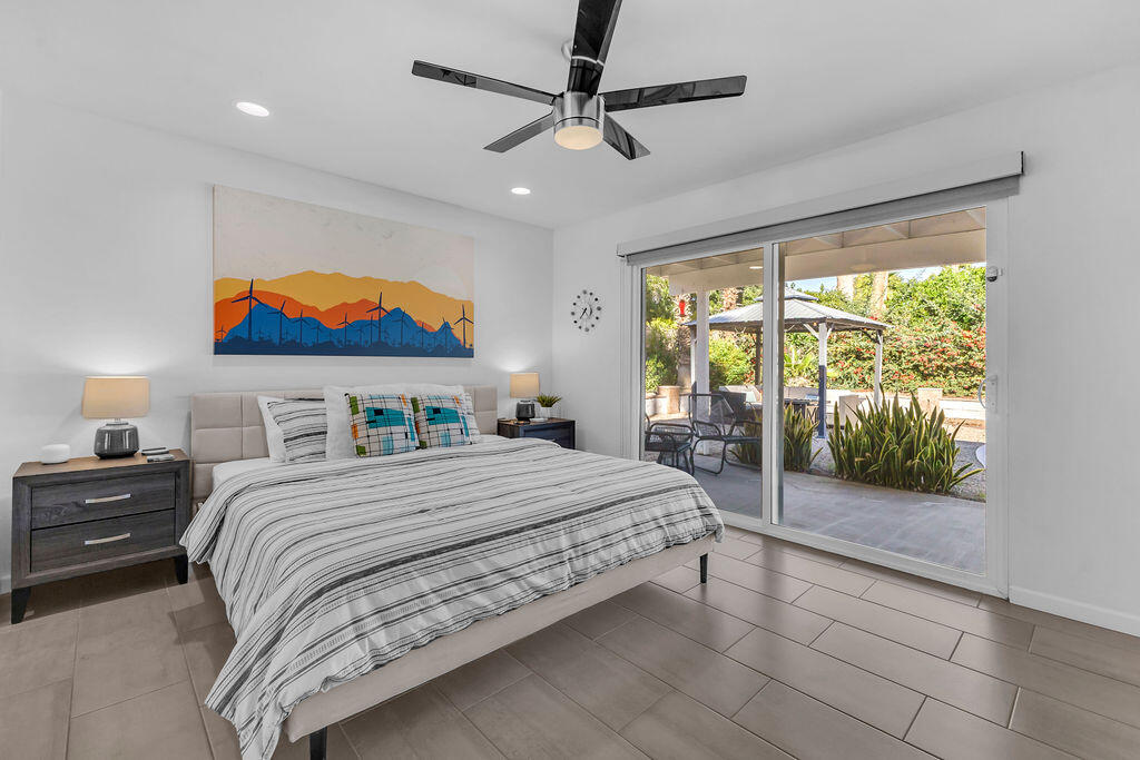 2304 East Bellamy Road Palm Springs, CA 92262 - Photo 17 of 32 a bedroom with a balcony a bed and a painting on the wall
