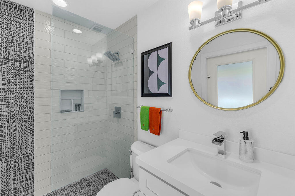 2304 East Bellamy Road Palm Springs, CA 92262 - Photo 20 of 32 a bathroom with a sink a toilet and a mirror