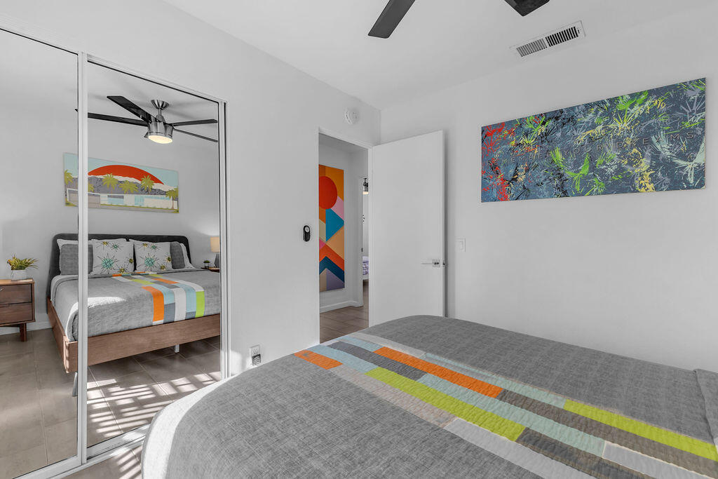 2304 East Bellamy Road Palm Springs, CA 92262 - Photo 24 of 32 a bedroom with bed and paintings on the wall