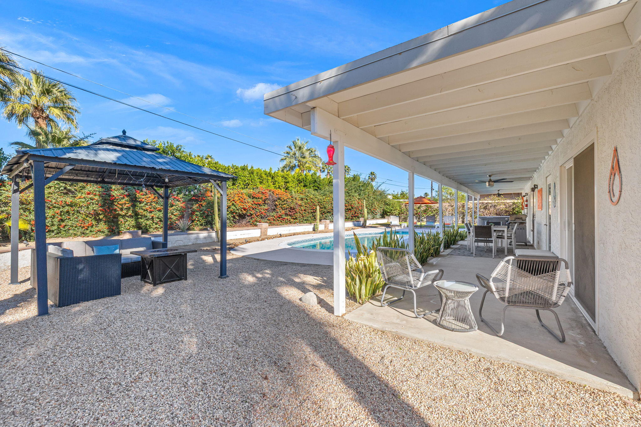 2304 East Bellamy Road Palm Springs, CA 92262 - Photo 7 of 32 a view of a patio with a table and chairs under an umbrella