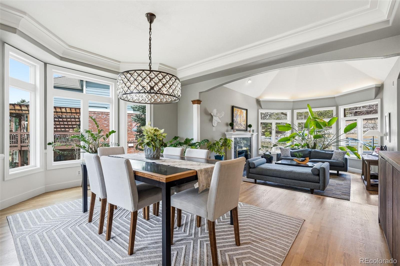77 Falcon Hills Drive Highlands Ranch, CO 80126 - Photo 13 of 43 a view of a dining room with furniture window and wooden floor