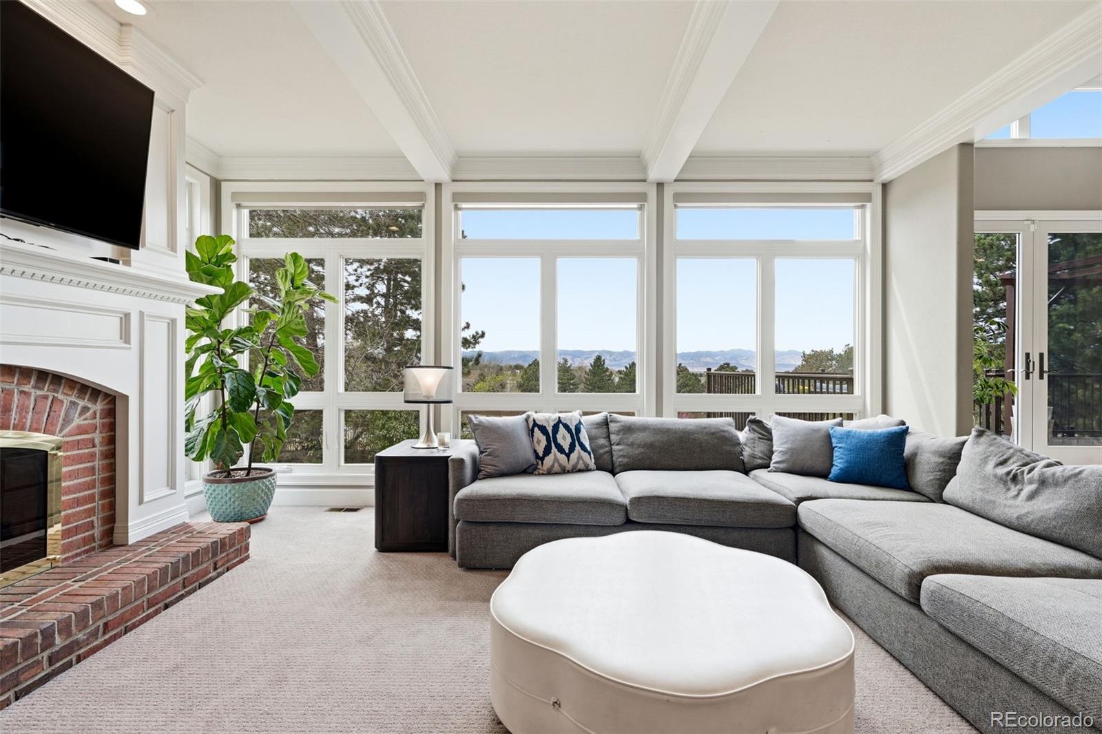 77 Falcon Hills Drive Highlands Ranch, CO 80126 - Photo 16 of 43 a living room with furniture a large window and a flat screen tv