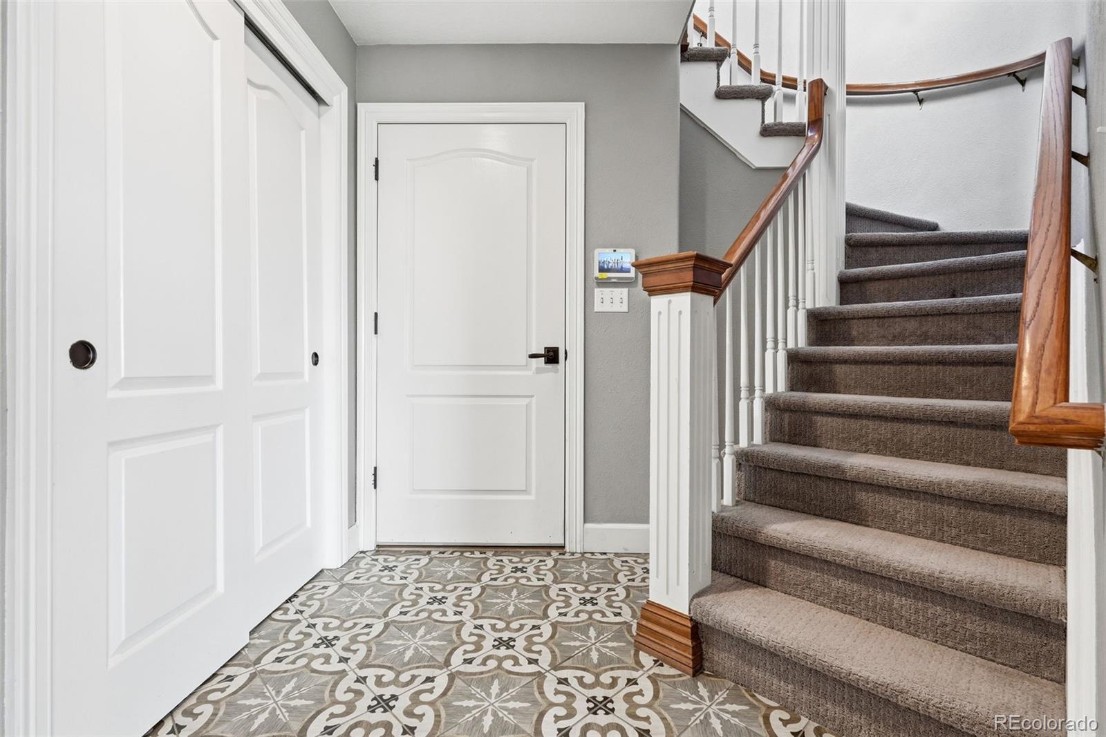 77 Falcon Hills Drive Highlands Ranch, CO 80126 - Photo 26 of 43 a view of an entryway with staircase