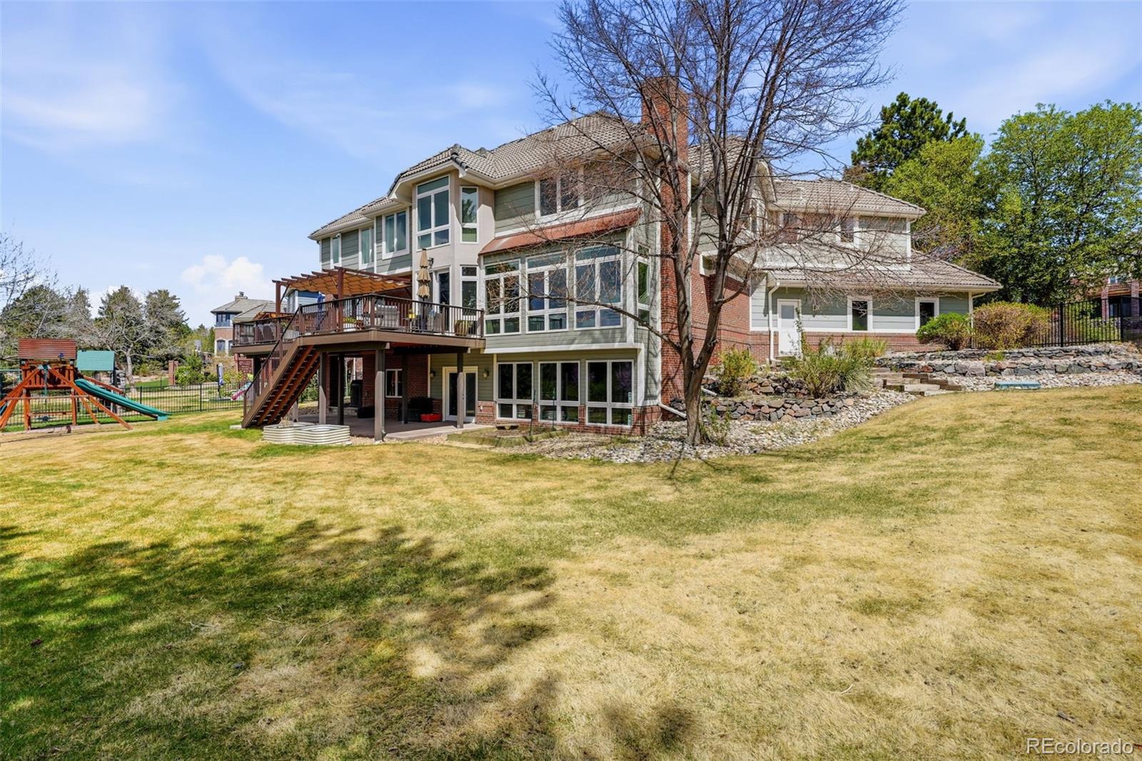 77 Falcon Hills Drive Highlands Ranch, CO 80126 - Photo 38 of 43 a front view of a building with a yard