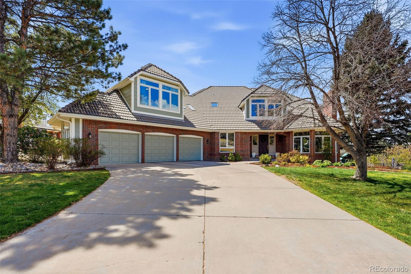 77 Falcon Hills Drive Highlands Ranch, CO 80126 - Photo 5 of 43 a front view of a house with yard and green space