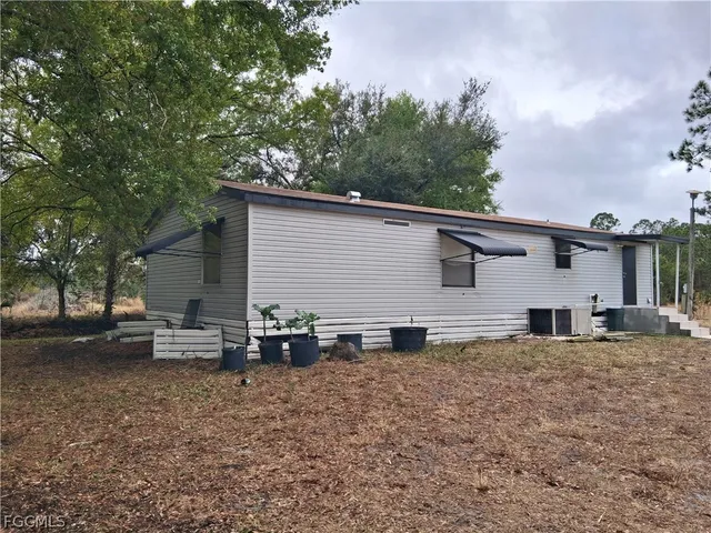 a view of a patio with table and chairs under an umbrella